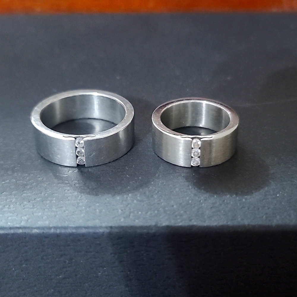His and hers stainless steel rings with 3 cubic zirconia